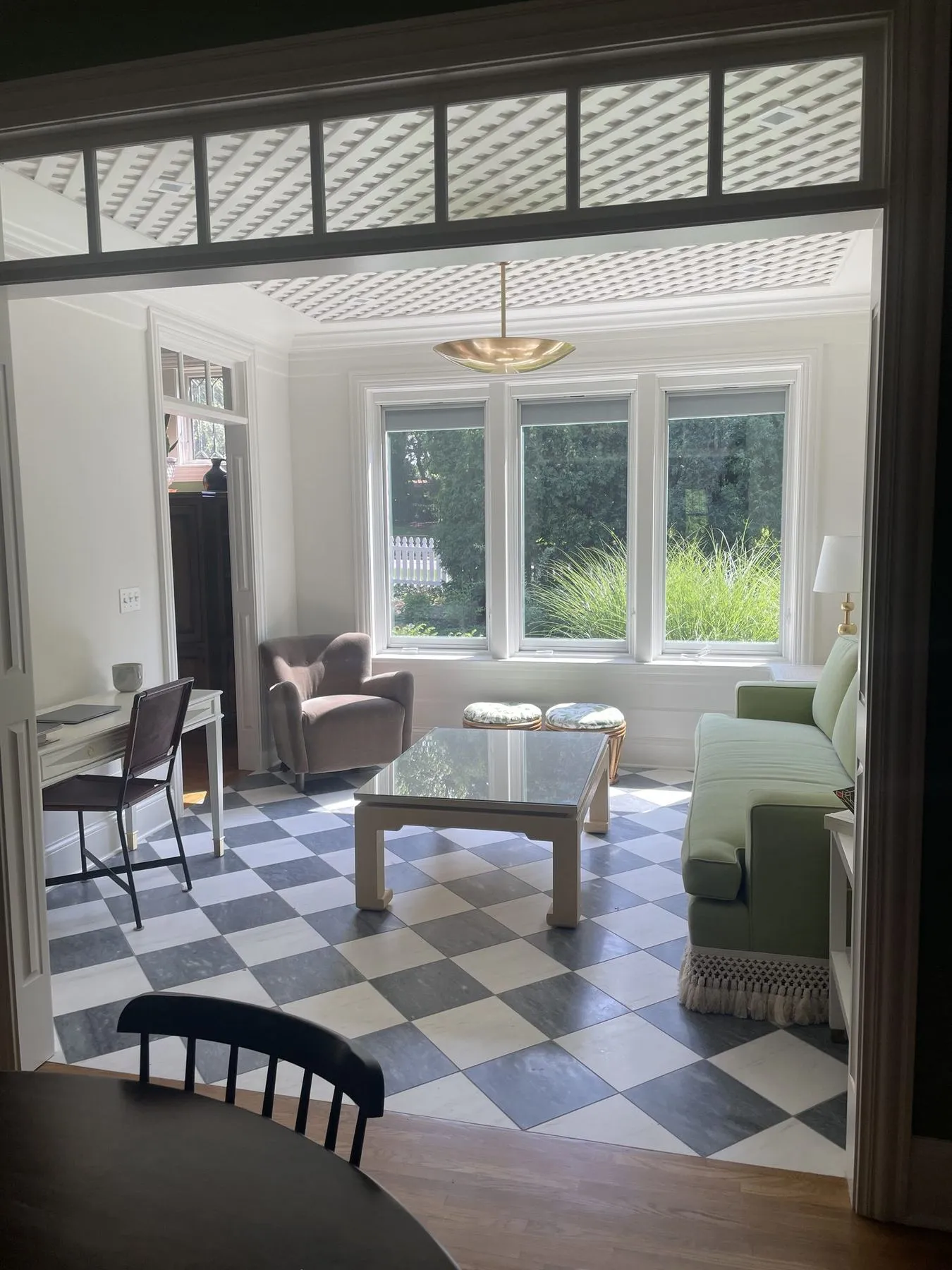 Sunroom seen through a transom-topped opening