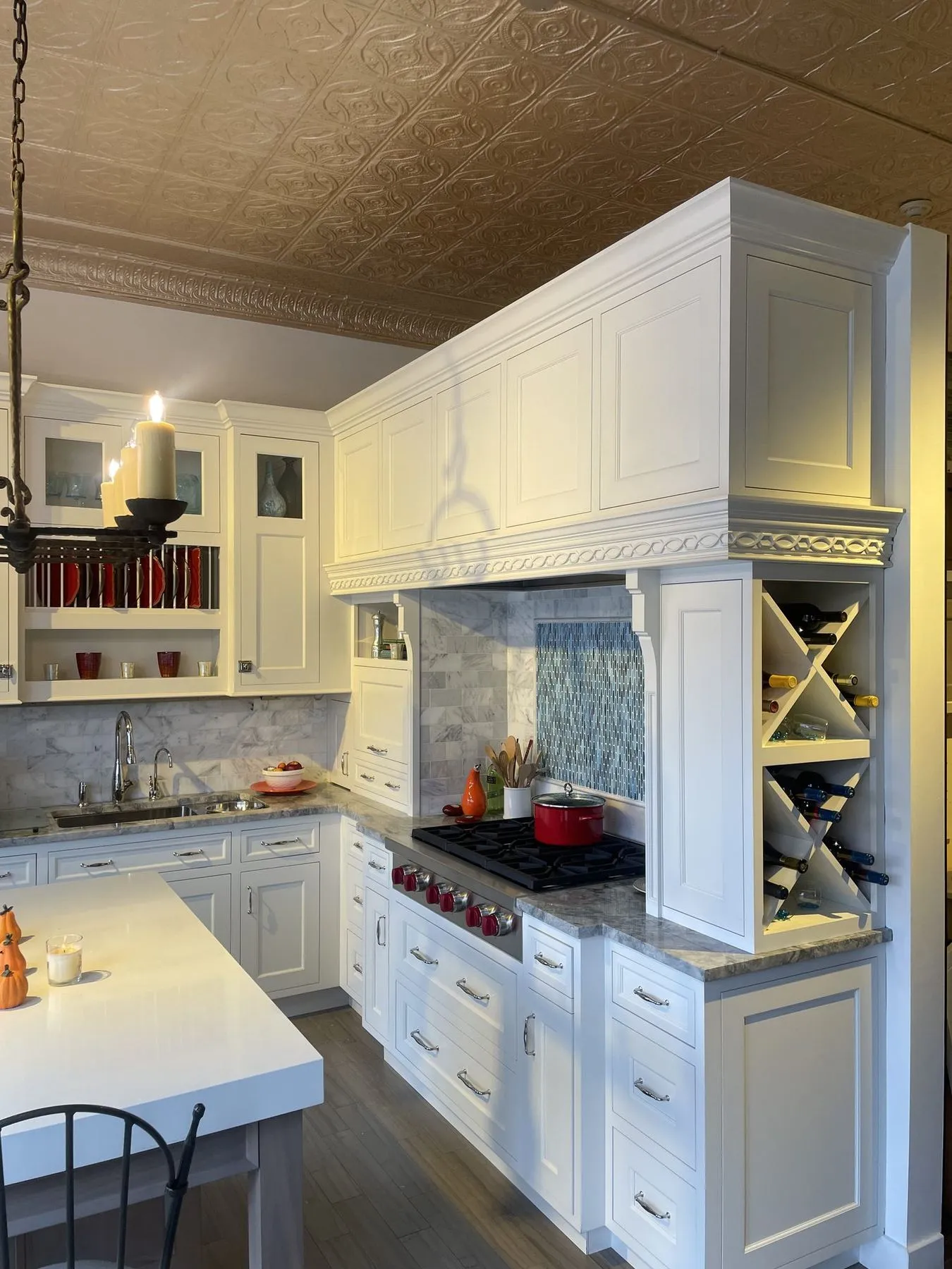 White range wall with a wine rack and tin ceiling