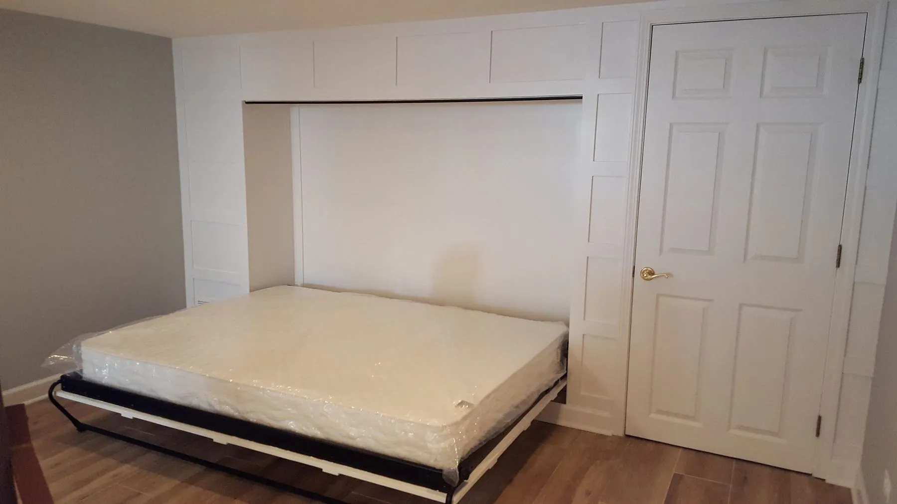 The same wall with a bed folded down