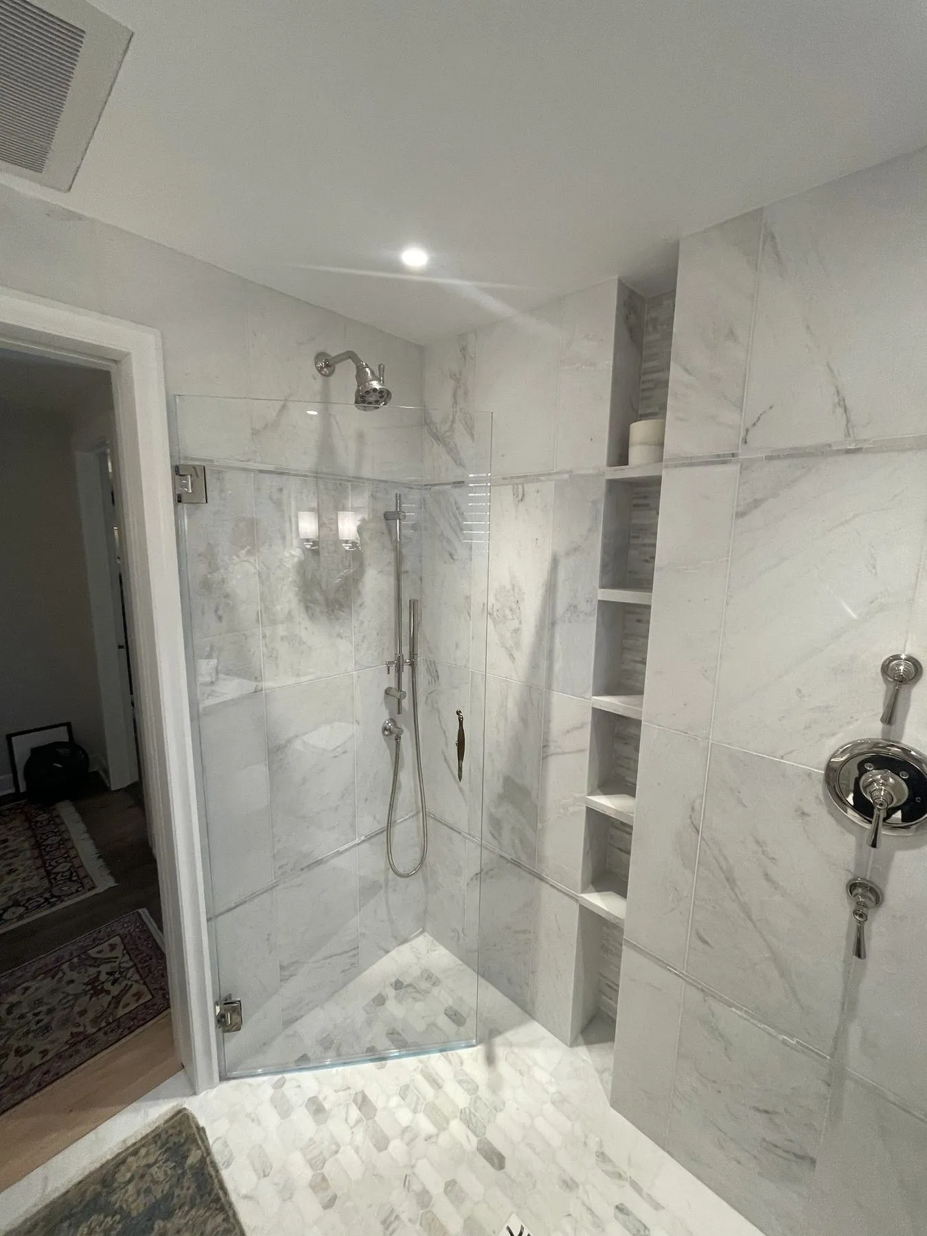 Frameless shower with a mosaic floor