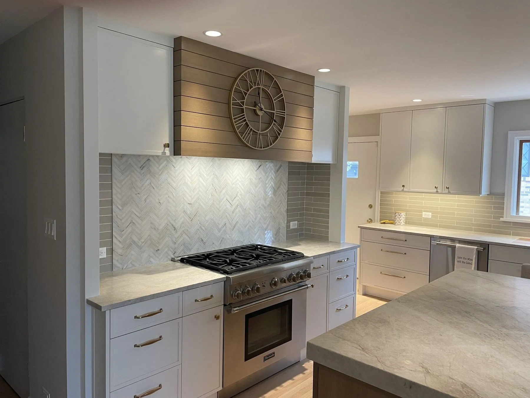 Kitchen with an oak island and plank hood