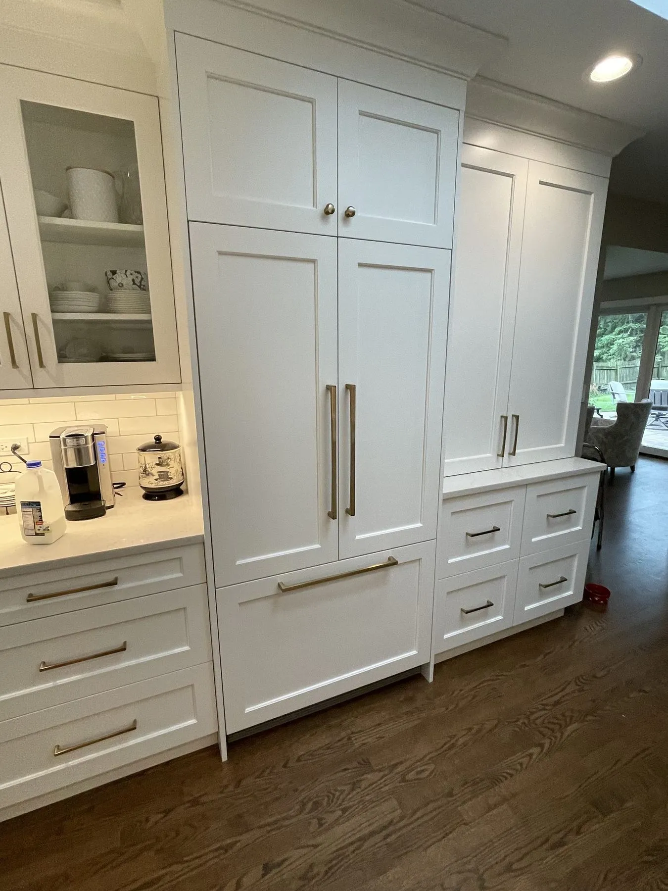 Tall pantry cabinets with brass pulls