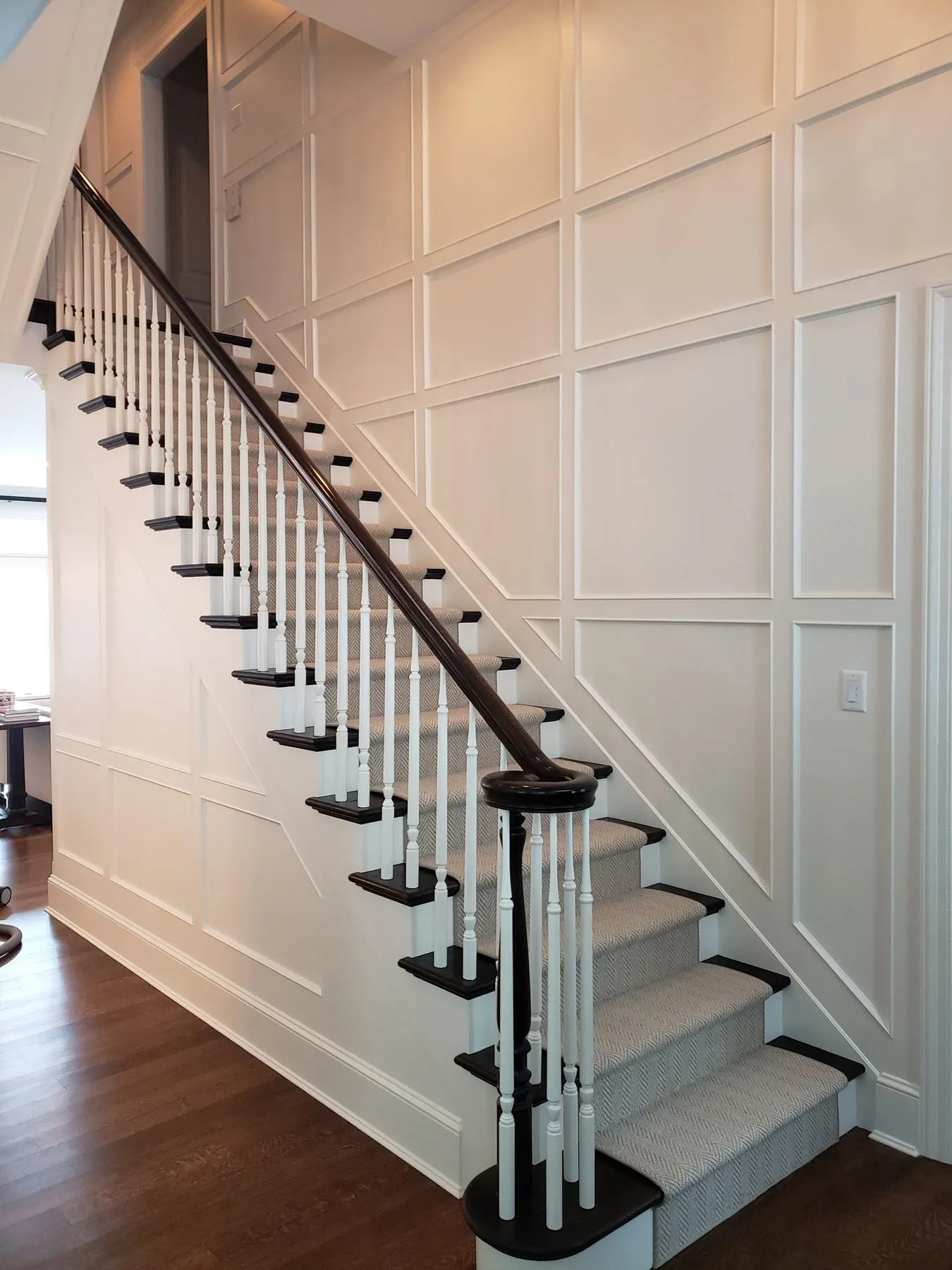 Paneled staircase, laundry, and mudroom