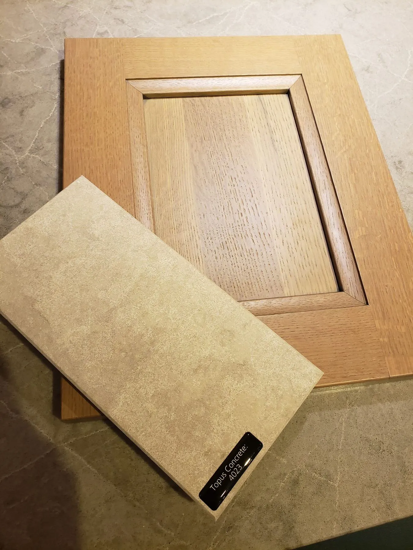 Cabinet door and tile samples on a countertop