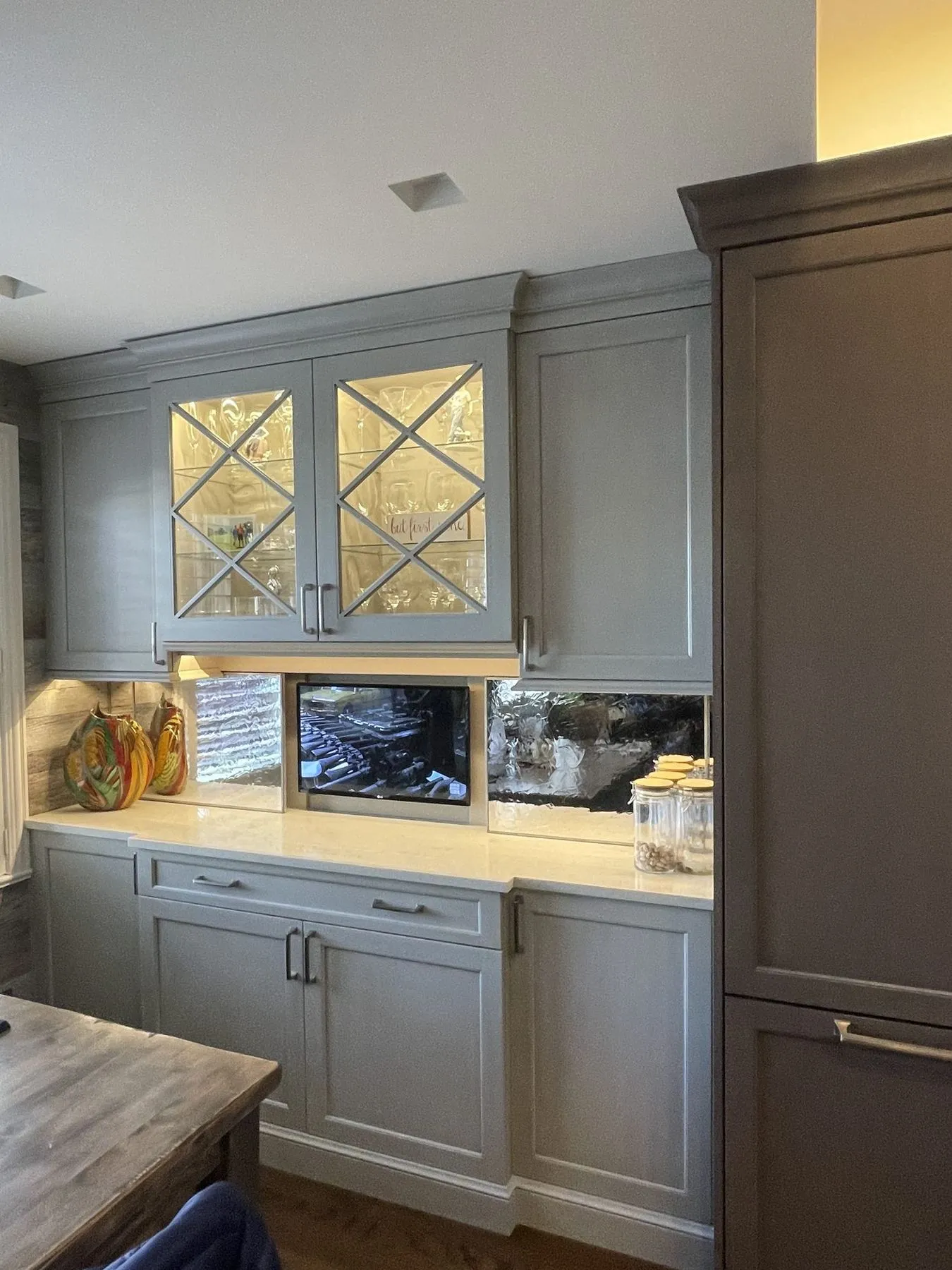 Glass-front cabinets and dark tall cabinet