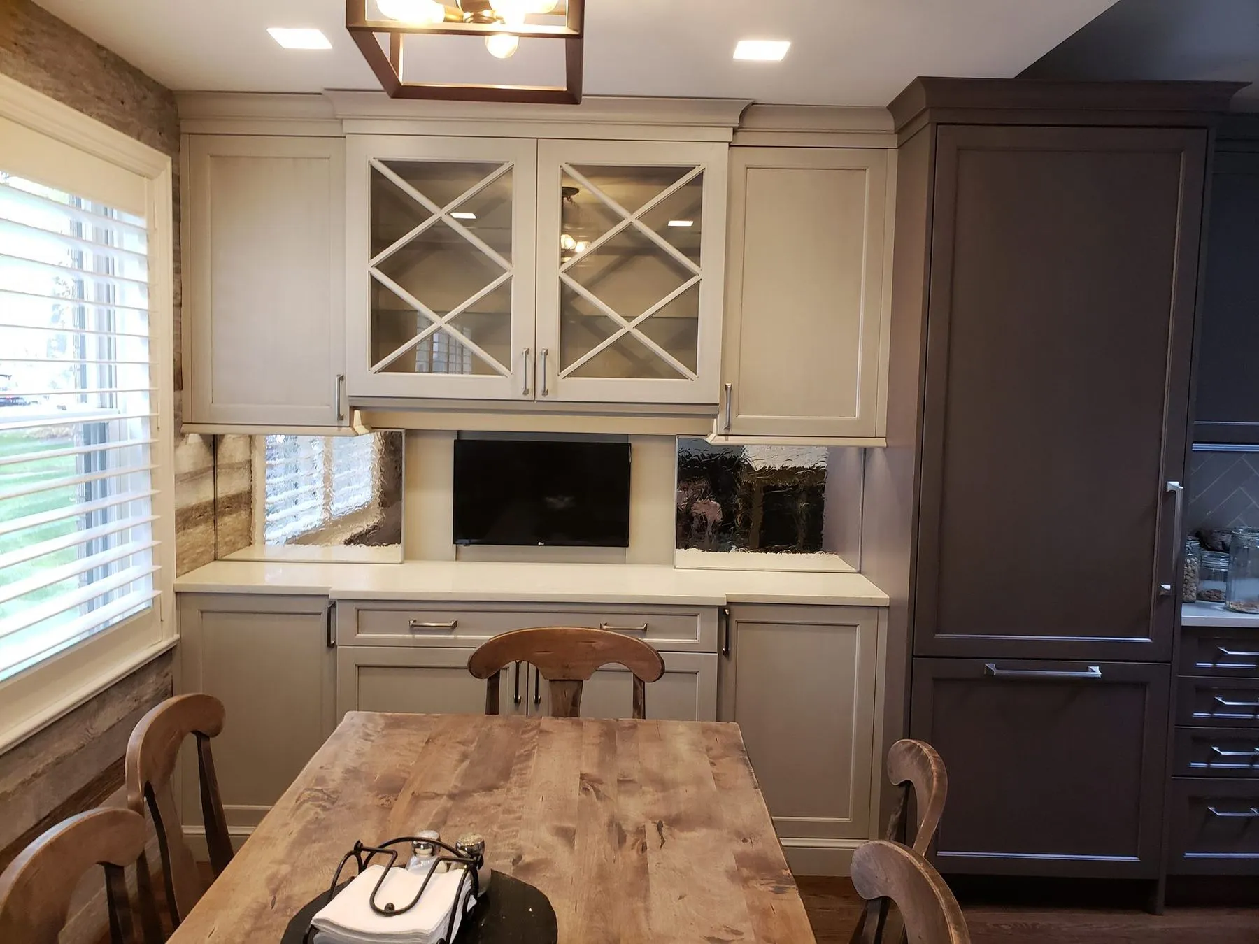Kitchen with a farmhouse table and glass-front cabinets