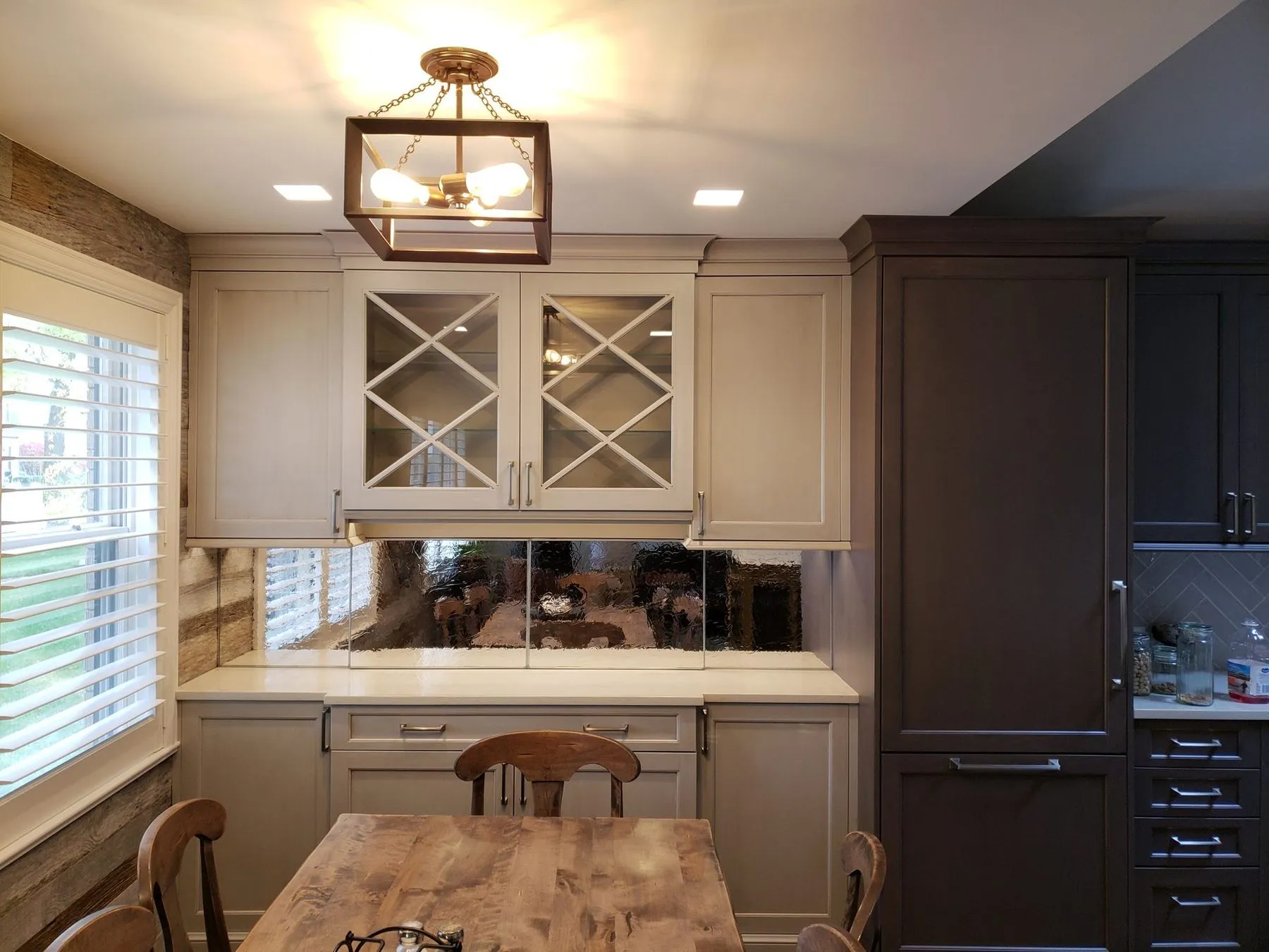 Kitchen with a lantern fixture and dark paneled cabinets