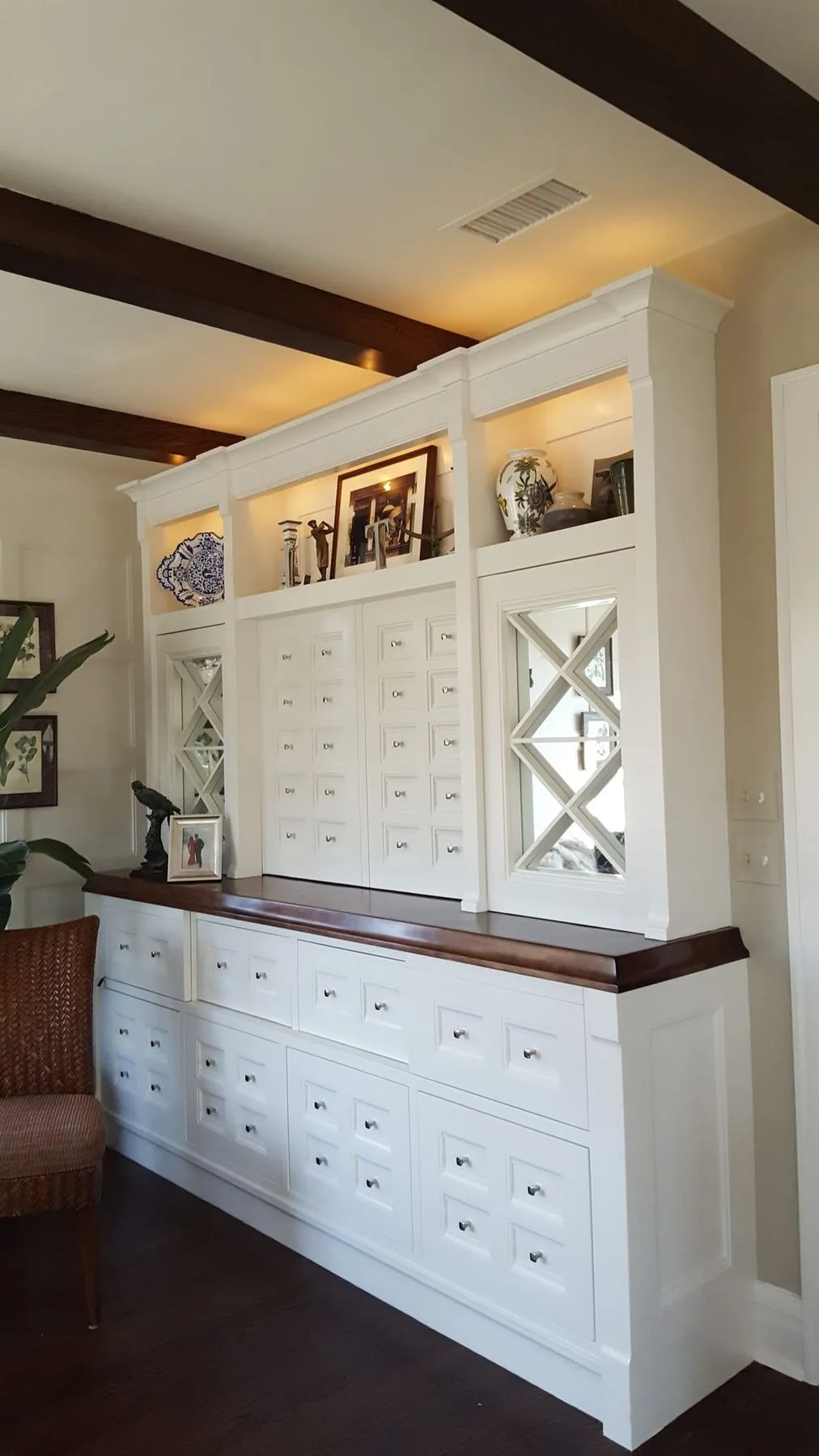 Built-in cabinet with apothecary drawers and glass doors